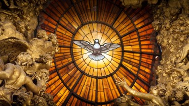 A window of yellow alabaster is illuminated at its centre with an image of the Dove of the Holy Spirit.  This is above the Cathedra Petri or "Chair of St. Peter" altar at St. Peter's Basilica.  The altar was created by Bernini.   Bernini created a large bronze throne in which it was housed, raised high on four looping supports held effortlessly by massive bronze statues of four Doctors of the Church, Saints Ambrose and Augustine representing the Latin Church and Athanasius and John Chrysostom, the Greek Church. The four figures are dynamic with sweeping robes and expressions of adoration and ecstasy.