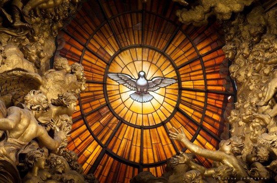A window of yellow alabaster is illuminated at its centre with an image of the Dove of the Holy Spirit.  This is above the Cathedra Petri or "Chair of St. Peter" altar at St. Peter's Basilica.  The altar was created by Bernini.   Bernini created a large bronze throne in which it was housed, raised high on four looping supports held effortlessly by massive bronze statues of four Doctors of the Church, Saints Ambrose and Augustine representing the Latin Church and Athanasius and John Chrysostom, the Greek Church. The four figures are dynamic with sweeping robes and expressions of adoration and ecstasy.